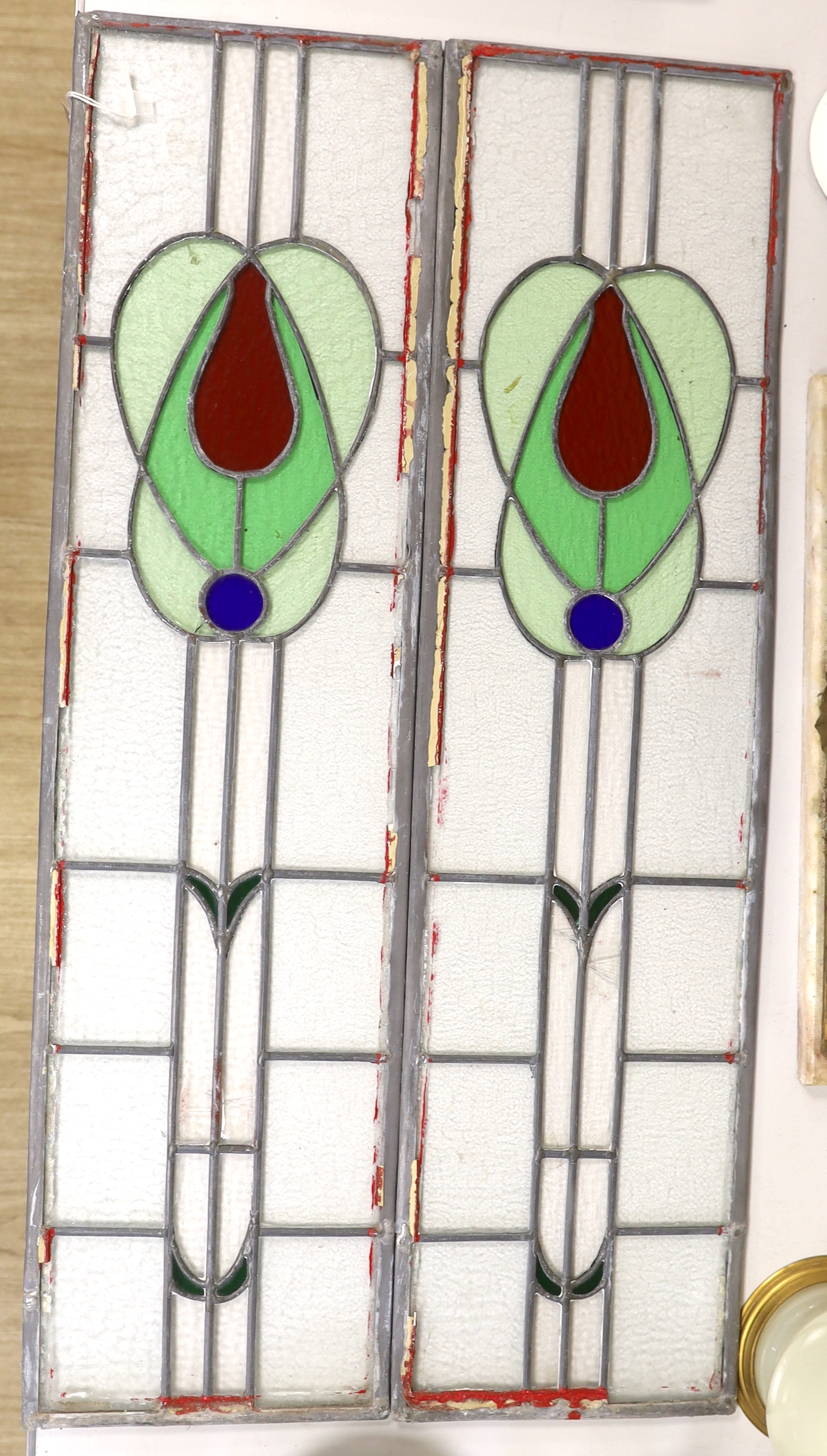 A pair of stained glass leaded panels, 98cm high x 25.5cm wide